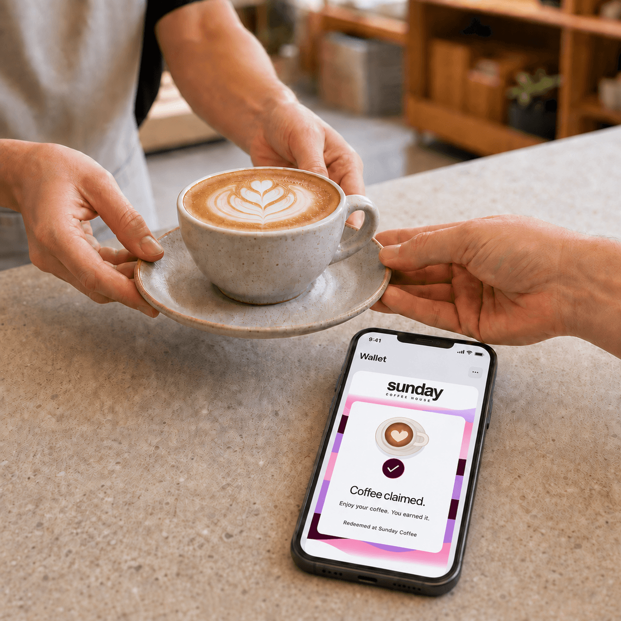 A customer receives their coffee while the phone shows the purple-and-pink Sunday Coffee card, coffee illustration and Coffee claimed confirmation. Illustrative reward experience.